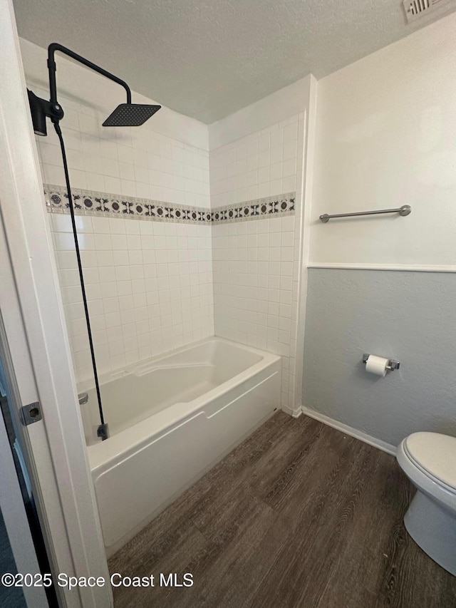 2681 Trammel Ave, Melbourne, FL 32935 - bathroom with wood finished floors,  shower combination, and a textured ceiling
