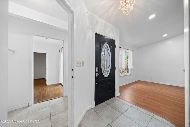 458 Stendal Rd NW, Palm Bay, FL 32907 - foyer featuring light tile patterned flooring, a chandelier, and recessed lighting