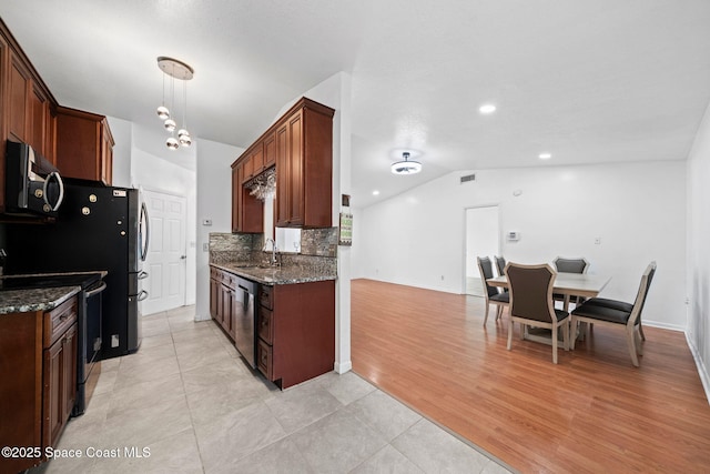 458 Stendal Rd NW, Palm Bay, FL 32907 - kitchen with stainless steel appliances, dark stone countertops, vaulted ceiling, tasteful backsplash, and light tile patterned flooring