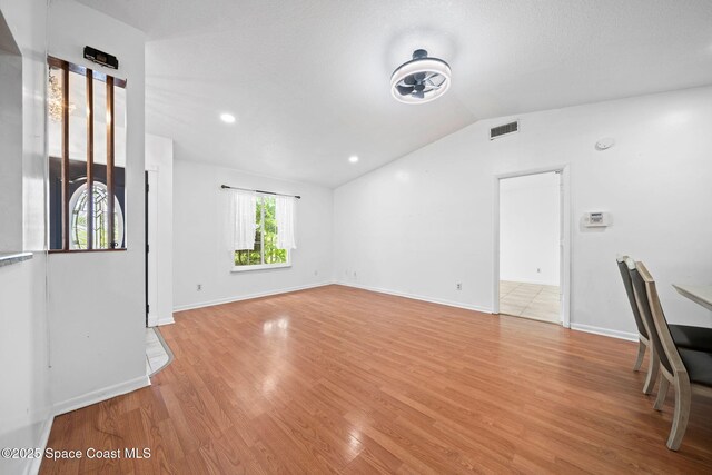 458 Stendal Rd NW, Palm Bay, FL 32907 - unfurnished living room with vaulted ceiling and light wood-type flooring