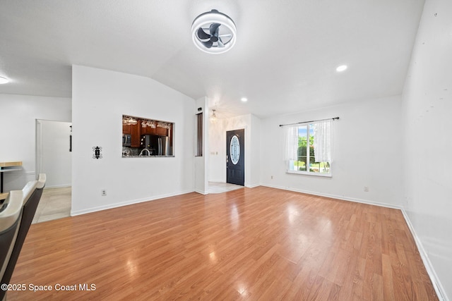 458 Stendal Rd NW, Palm Bay, FL 32907 - unfurnished living room with vaulted ceiling, light wood-type flooring, a ceiling fan, and recessed lighting