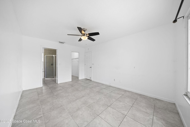 458 Stendal Rd NW, Palm Bay, FL 32907 - unfurnished bedroom with light tile patterned flooring, a closet, ceiling fan, and a walk in closet