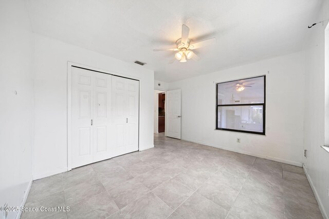 458 Stendal Rd NW, Palm Bay, FL 32907 - unfurnished bedroom with a closet and a ceiling fan