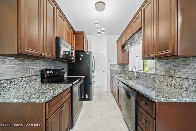 458 Stendal Rd NW, Palm Bay, FL 32907 - kitchen featuring appliances with stainless steel finishes, decorative backsplash, dark stone counters, and hanging light fixtures