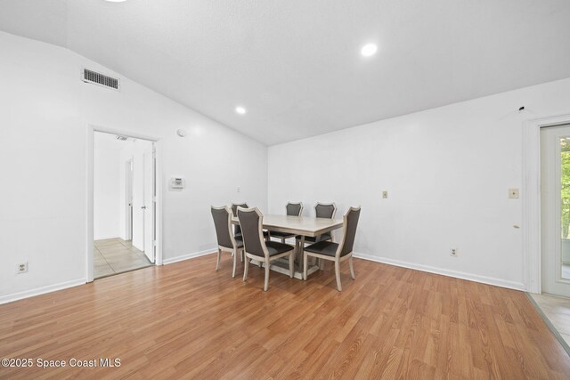 458 Stendal Rd NW, Palm Bay, FL 32907 - dining room featuring vaulted ceiling, light wood-style floors, and recessed lighting