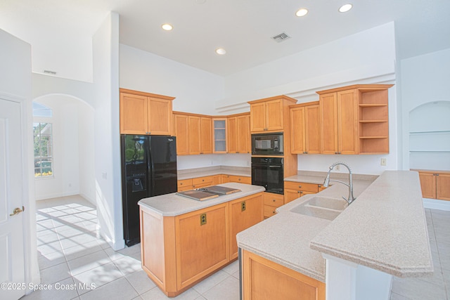 4180 Stoney Point Rd, Melbourne, FL 32940 - kitchen with black appliances, open shelves, a center island, arched walkways, and a peninsula