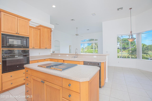 4180 Stoney Point Rd, Melbourne, FL 32940 - kitchen featuring black appliances, a peninsula, light countertops, light tile patterned floors, and recessed lighting