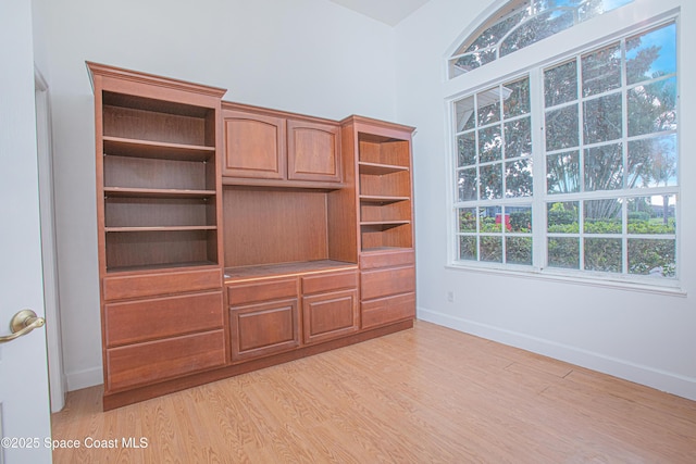 4180 Stoney Point Rd, Melbourne, FL 32940 - unfurnished living room featuring baseboards and light wood-style flooring