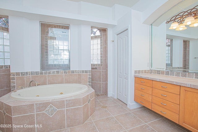 4180 Stoney Point Rd, Melbourne, FL 32940 - full bathroom with a tub with jets, vanity, and tile patterned floors
