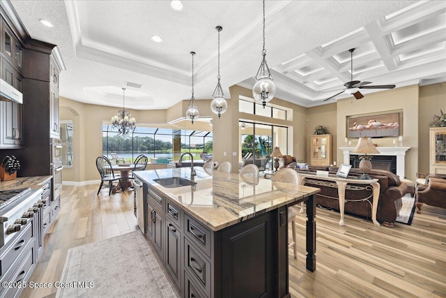 4464 Preservation Cir, Melbourne, FL 32934 - kitchen with a chandelier, light wood-style floors, ceiling fan, a kitchen breakfast bar, and healthy amount of natural light
