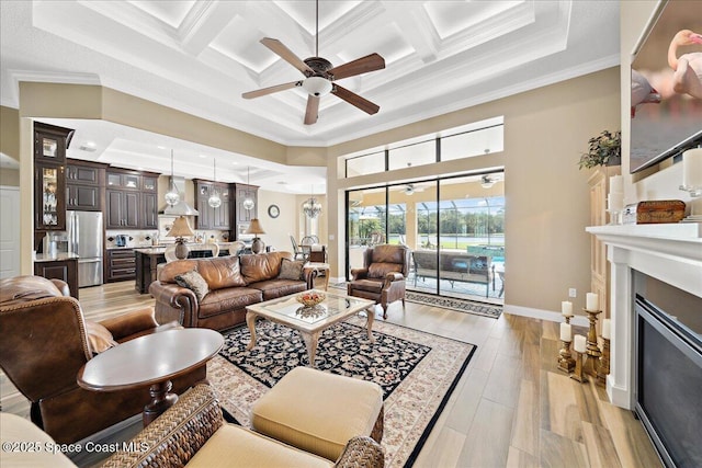 4464 Preservation Cir, Melbourne, FL 32934 - living room featuring ceiling fan, crown molding, coffered ceiling, a high ceiling, and beam ceiling