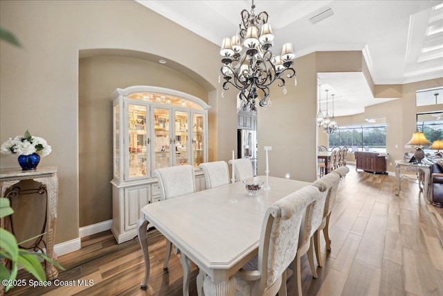 4464 Preservation Cir, Melbourne, FL 32934 - dining room featuring a chandelier, ornamental molding, and wood finished floors