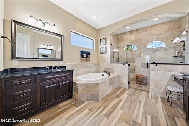 4464 Preservation Cir, Melbourne, FL 32934 - full bathroom featuring a bath, vanity, walk in shower, wood finished floors, and recessed lighting