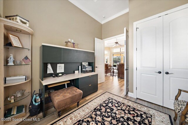 4464 Preservation Cir, Melbourne, FL 32934 - home office featuring crown molding, light wood finished floors, a ceiling fan, and high vaulted ceiling