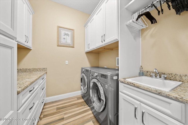 4464 Preservation Cir, Melbourne, FL 32934 - washroom with cabinet space, washer and dryer, and light wood-style flooring