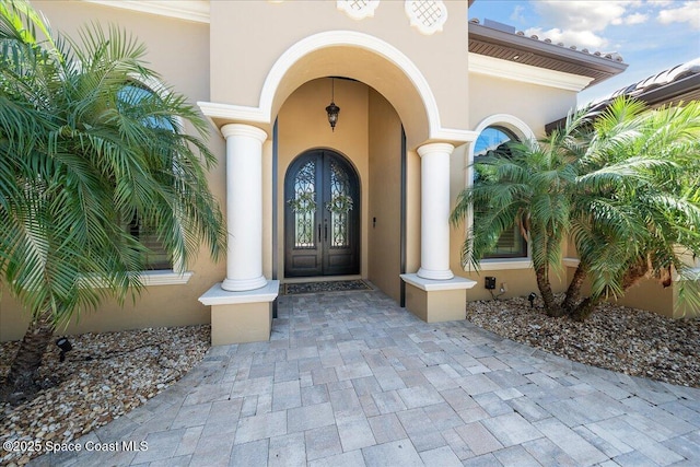 4464 Preservation Cir, Melbourne, FL 32934 - view of exterior entry with french doors and stucco siding