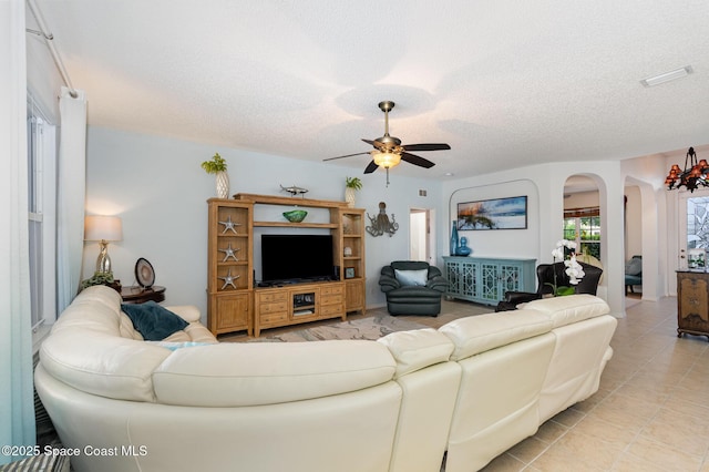 4185 Fenrose Cir, Melbourne, FL 32940 - living area with arched walkways, a ceiling fan, a textured ceiling, and light tile patterned flooring