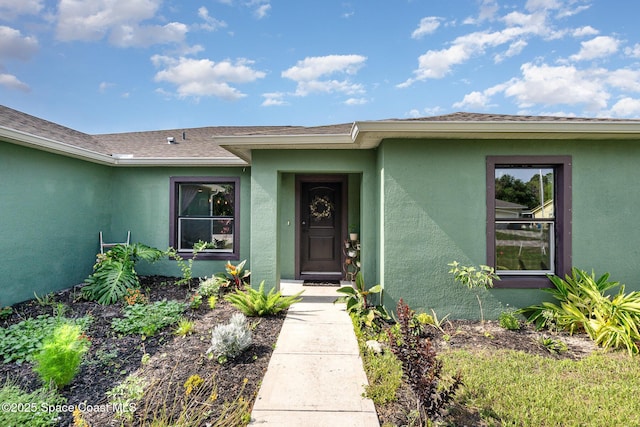 950 Douglas St SE, Palm Bay, FL 32909 - entrance to property with stucco siding and a shingled roof