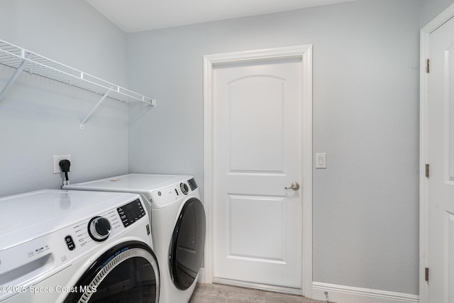 950 Douglas St SE, Palm Bay, FL 32909 - laundry room featuring separate washer and dryer and light wood-type flooring
