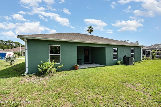 950 Douglas St SE, Palm Bay, FL 32909 - rear view of house with stucco siding, a lawn, and a patio