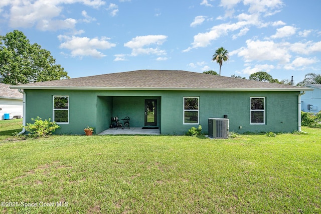 950 Douglas St SE, Palm Bay, FL 32909 - back of property with stucco siding, a patio area, a yard, and a shingled roof