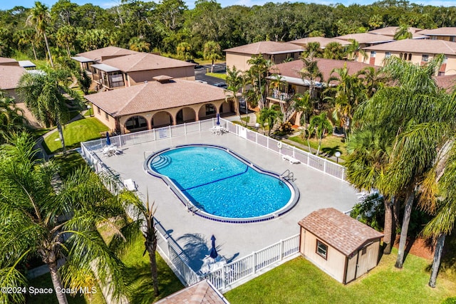 116 San Paulo Cir Unit 16-116, West Melbourne, FL 32904 - community pool featuring a residential view and an outbuilding