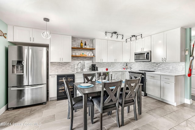 116 San Paulo Cir Unit 16-116, West Melbourne, FL 32904 - kitchen featuring appliances with stainless steel finishes, tasteful backsplash, light countertops, white cabinets, and open shelves
