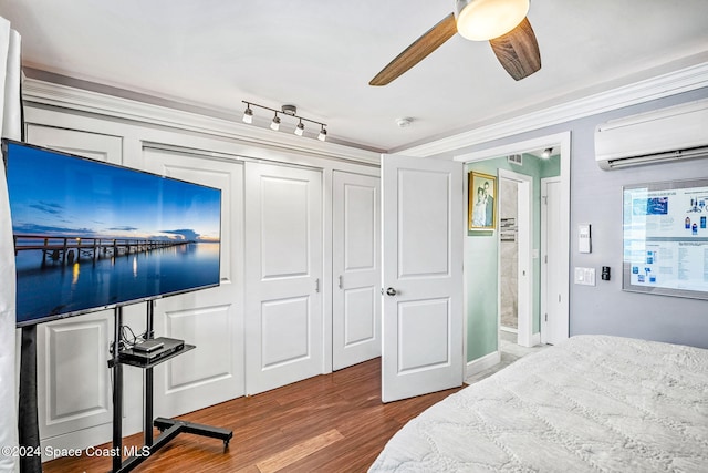 116 San Paulo Cir Unit 16-116, West Melbourne, FL 32904 - bedroom with a wall mounted AC, wood finished floors, ornamental molding, a closet, and a ceiling fan