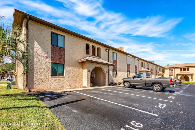 116 San Paulo Cir Unit 16-116, West Melbourne, FL 32904 - view of building exterior with uncovered parking
