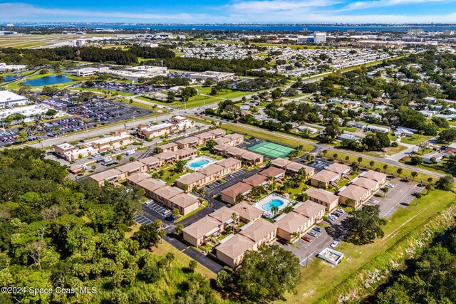 116 San Paulo Cir Unit 16-116, West Melbourne, FL 32904 - drone / aerial view of a pool and a nearby body of water