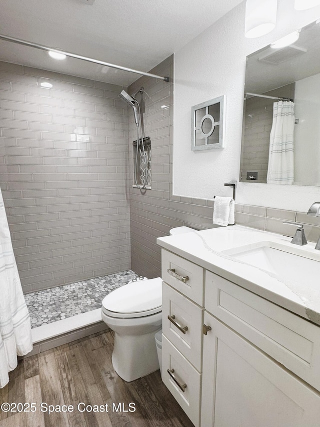 225 Buccaneer Ave Unit C2-207, Merritt Island, FL 32952 - full bath with vanity, wood finished floors, and tiled shower