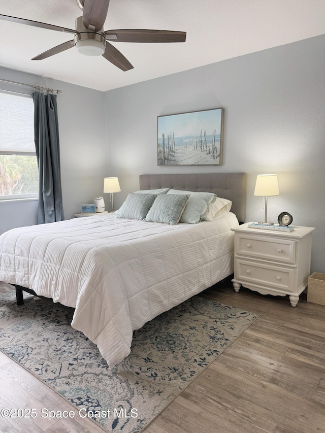 225 Buccaneer Ave Unit C2-207, Merritt Island, FL 32952 - bedroom with wood finished floors and ceiling fan