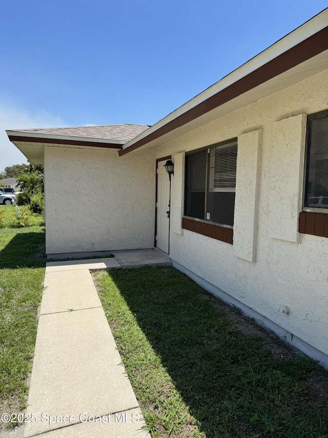 1112 Wabash Rd SE, Palm Bay, FL 32909 - entrance to property with stucco siding and a yard