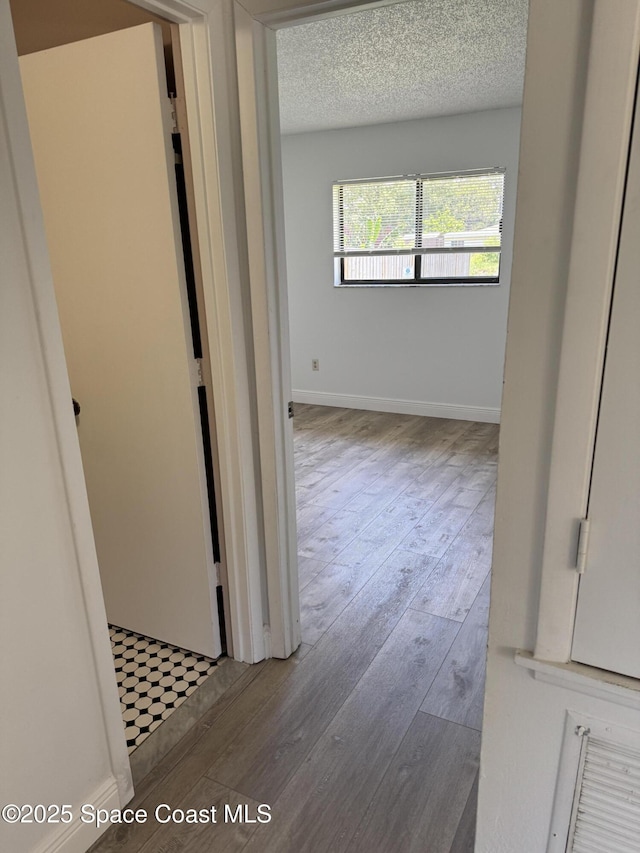 1112 Wabash Rd SE, Palm Bay, FL 32909 - corridor featuring hardwood / wood-style flooring and a textured ceiling
