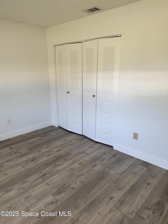 1112 Wabash Rd SE, Palm Bay, FL 32909 - unfurnished bedroom featuring wood finished floors and a closet