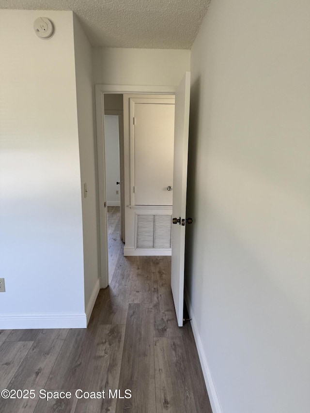 1112 Wabash Rd SE, Palm Bay, FL 32909 - hallway with wood finished floors and a textured ceiling