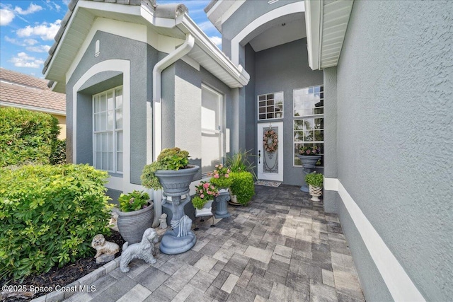 984 Wimbledon Dr, Melbourne, FL 32940 - entrance to property featuring stucco siding and a patio