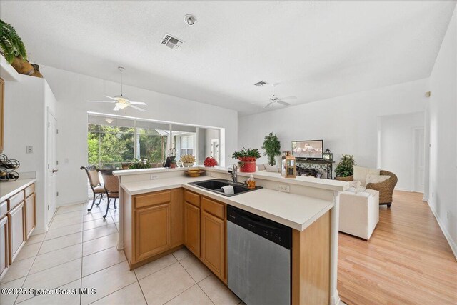 984 Wimbledon Dr, Melbourne, FL 32940 - kitchen featuring stainless steel dishwasher, ceiling fan, open floor plan, and light countertops