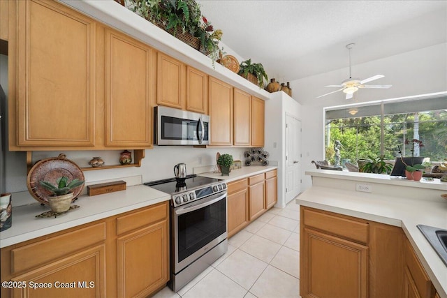 984 Wimbledon Dr, Melbourne, FL 32940 - kitchen featuring stainless steel appliances, light tile patterned flooring, light countertops, ceiling fan, and vaulted ceiling