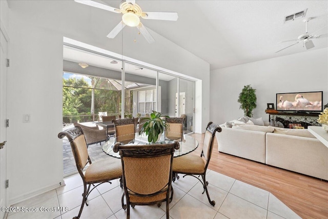 984 Wimbledon Dr, Melbourne, FL 32940 - dining room with ceiling fan, vaulted ceiling, light tile patterned floors, and a sunroom