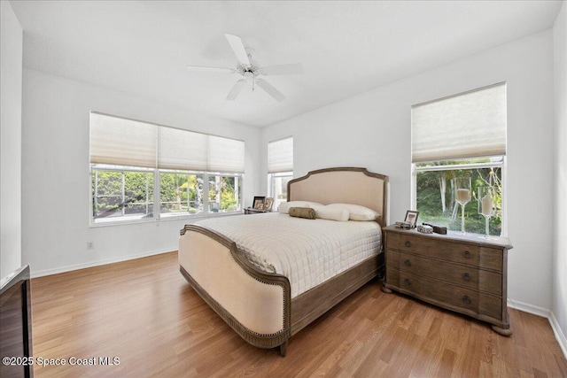 984 Wimbledon Dr, Melbourne, FL 32940 - bedroom featuring light wood-style floors, multiple windows, and a ceiling fan