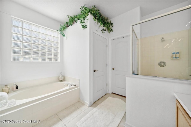 984 Wimbledon Dr, Melbourne, FL 32940 - bathroom with tile patterned flooring, tiled shower, a garden tub, and vanity