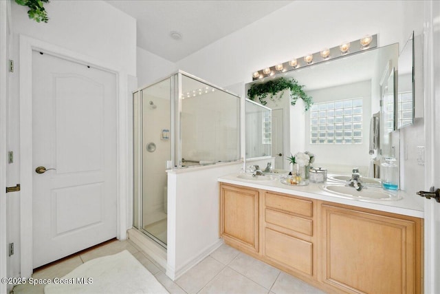 984 Wimbledon Dr, Melbourne, FL 32940 - bathroom with tile patterned flooring, a shower stall, and double vanity