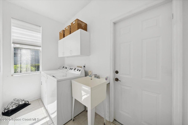 984 Wimbledon Dr, Melbourne, FL 32940 - laundry area with cabinet space, washer and dryer, and light tile patterned flooring