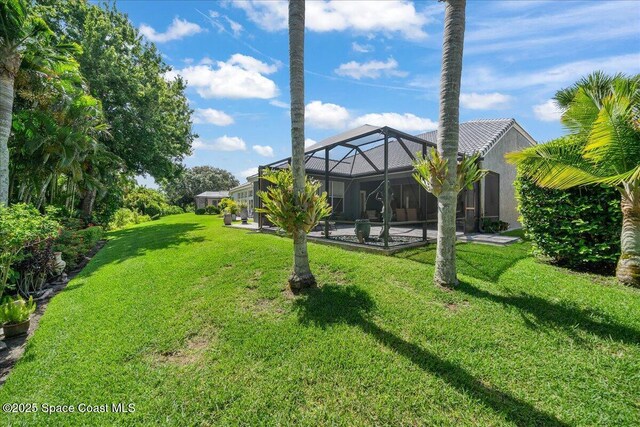 984 Wimbledon Dr, Melbourne, FL 32940 - view of grassy yard with a patio, an outdoor pool, and glass enclosure