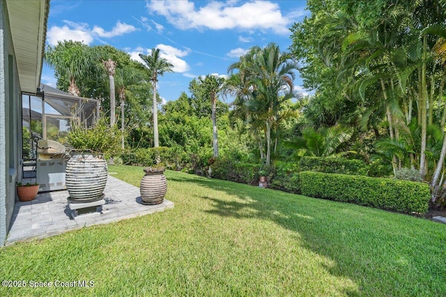 984 Wimbledon Dr, Melbourne, FL 32940 - view of grassy yard featuring a patio area and glass enclosure