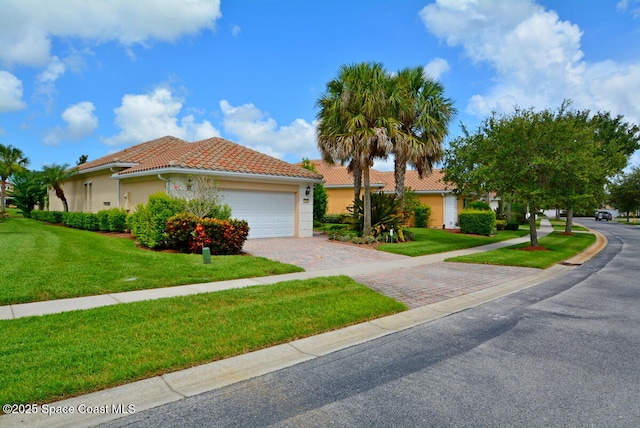 3531 Plume Way SE, Palm Bay, FL 32909 - view of front of property with decorative driveway, a garage, a front yard, a tile roof, and stucco siding