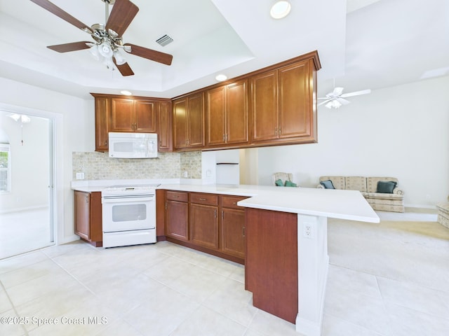 3531 Plume Way SE, Palm Bay, FL 32909 - kitchen featuring white appliances, a peninsula, light countertops, decorative backsplash, and ceiling fan