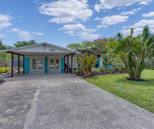 936 Santa Cruz Rd, Cocoa Beach, FL 32931 - view of front of home with french doors and concrete driveway