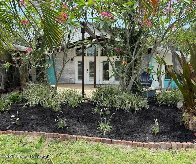 936 Santa Cruz Rd, Cocoa Beach, FL 32931 - view of side of home with brick siding and french doors